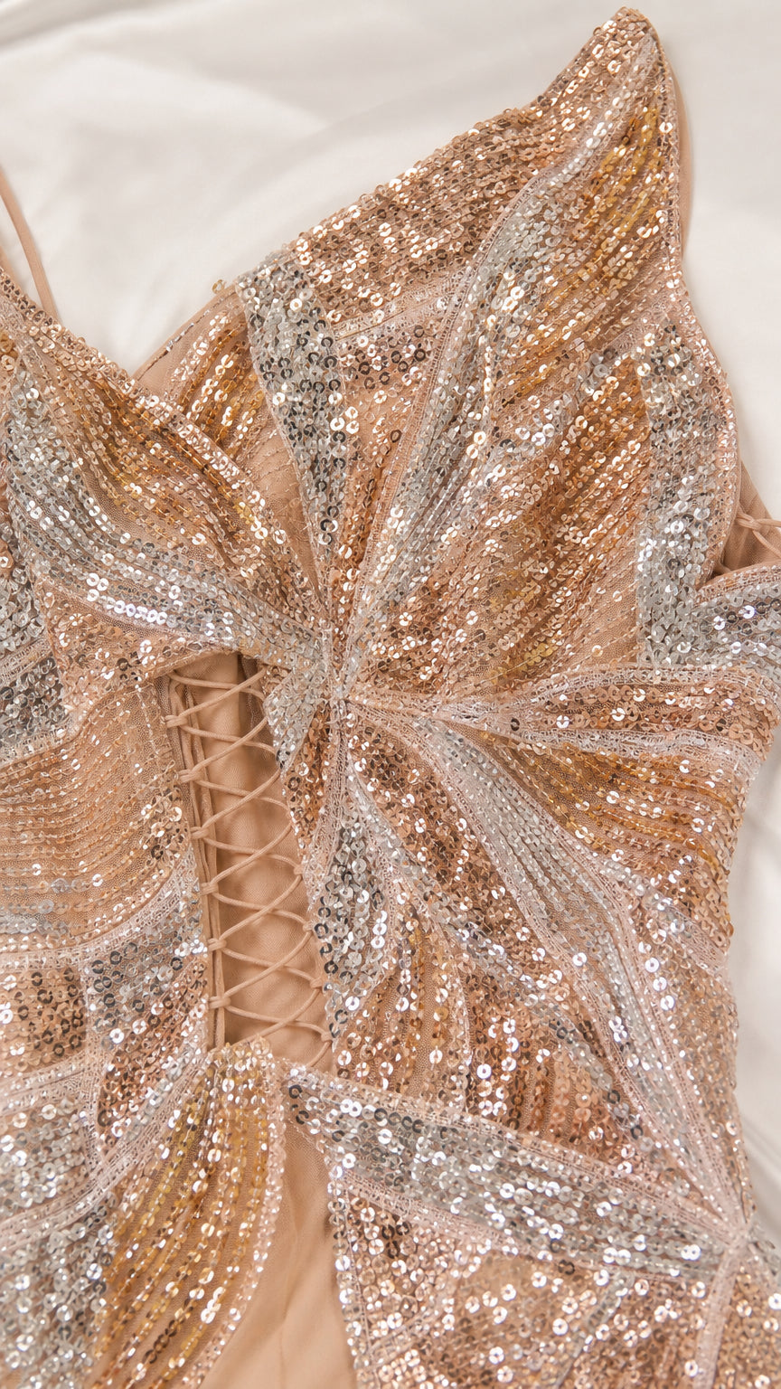 Close-up detail of silver and gold sequin embroidery with lace-up side ties