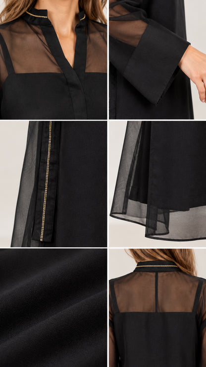 Close-up details of black sheer dress neckline, cuffs, and trim craftsmanship