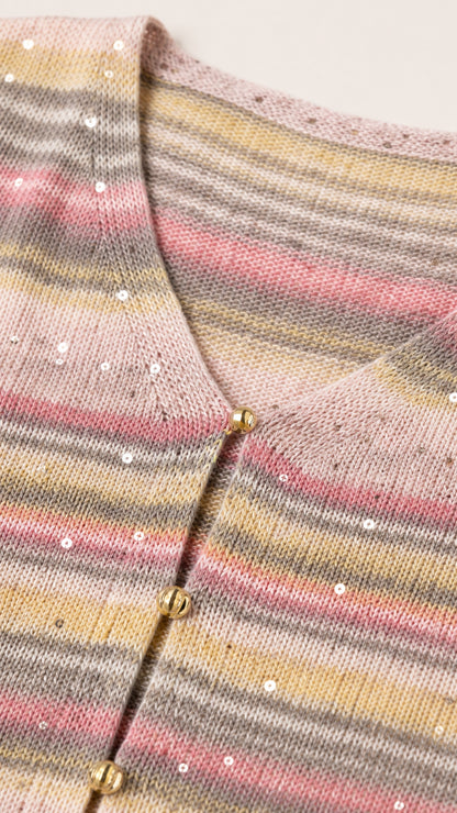 Close-up of pastel pink multi striped knit texture with subtle sequins and gold ball buttons