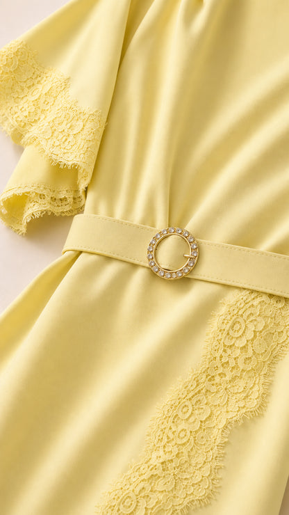 Close-up of flutter sleeve and belt detail on yellow dress