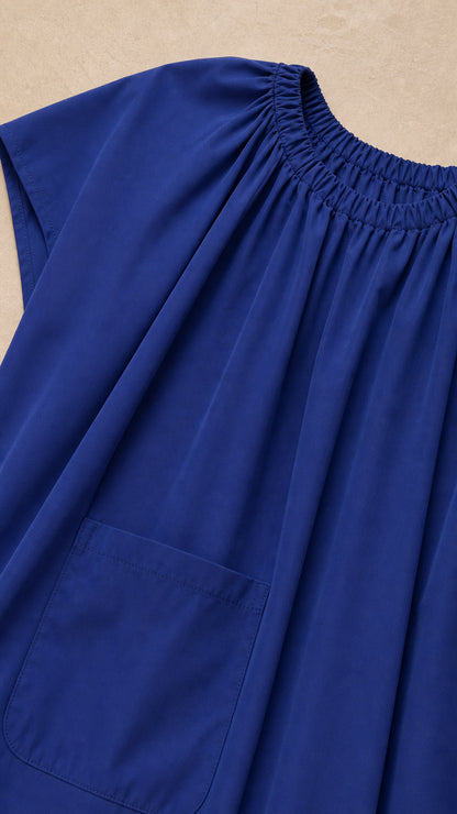 Close-up detail of shirred neckline and smooth woven fabric in Royal Blue