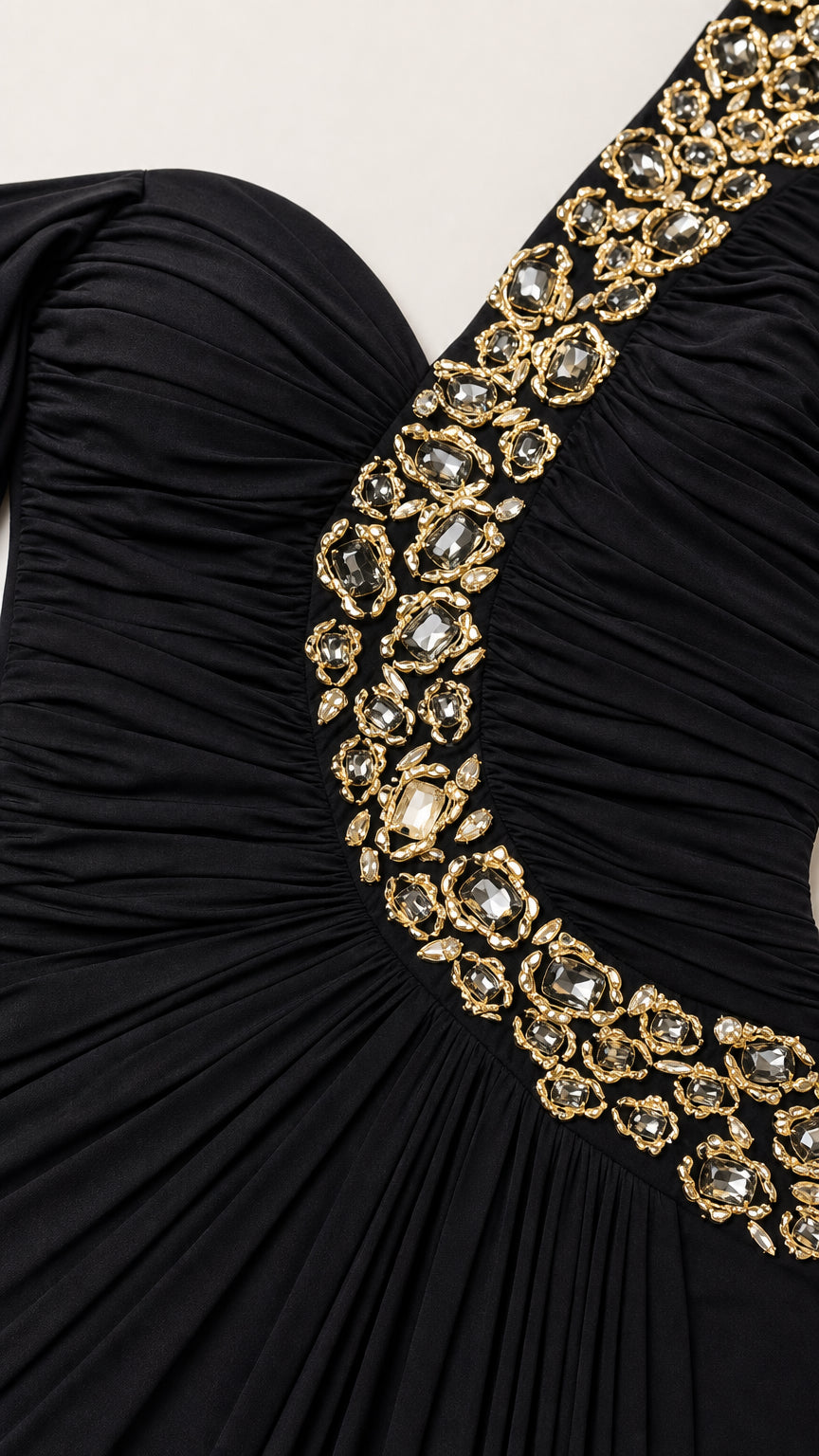 Close-up detail of sparkling crystal rhinestone embellishments on ruched black dress bodice