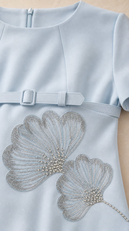 Close-up detail of Light Blue dress showing intricate beaded leaf embroidery and fabric belt