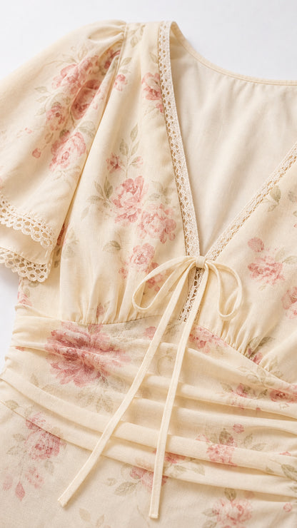Close-up detail of lace trim, V-neck, and front ties