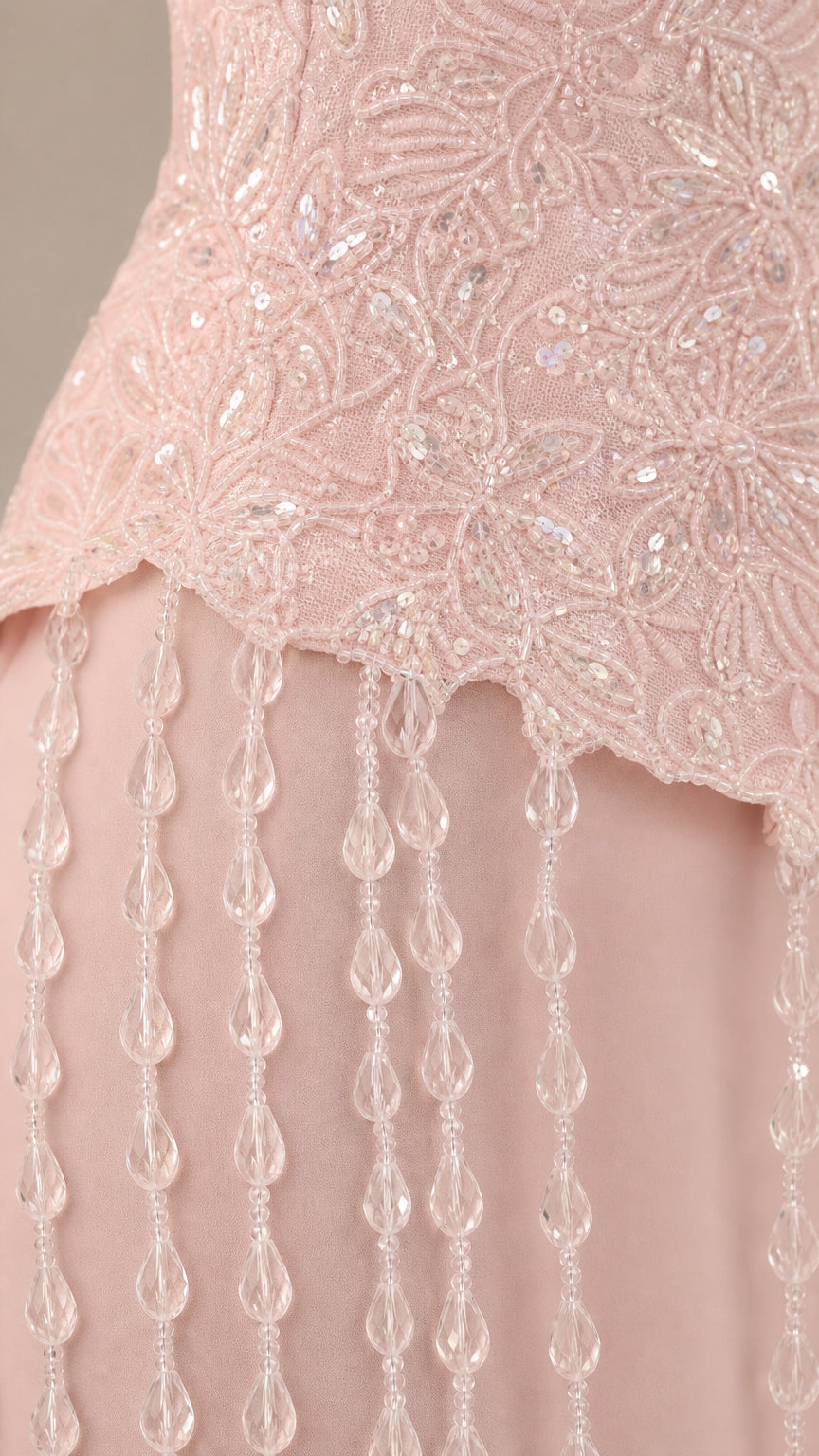 Close up of blush pink sequin lace bodice with dangling bead trim
