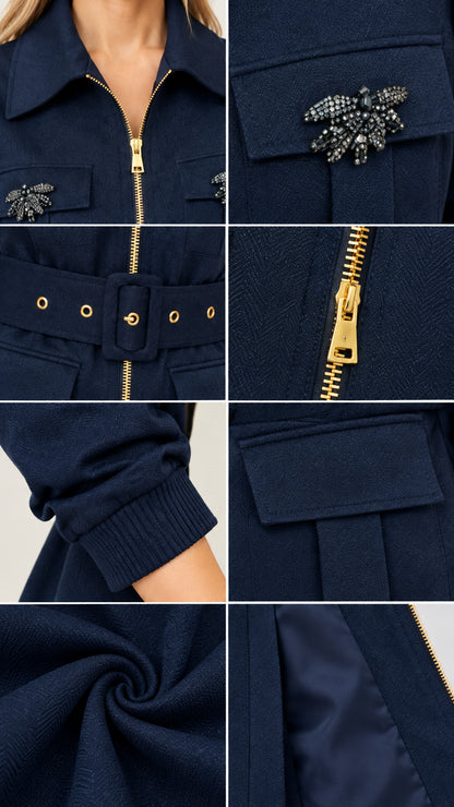 Close-up details of gold zipper, crystal brooch pocket, eyelet belt, and fabric texture