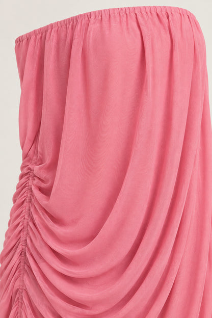 Close-up detail of side ruching and draped fabric on rose pink maxi dress