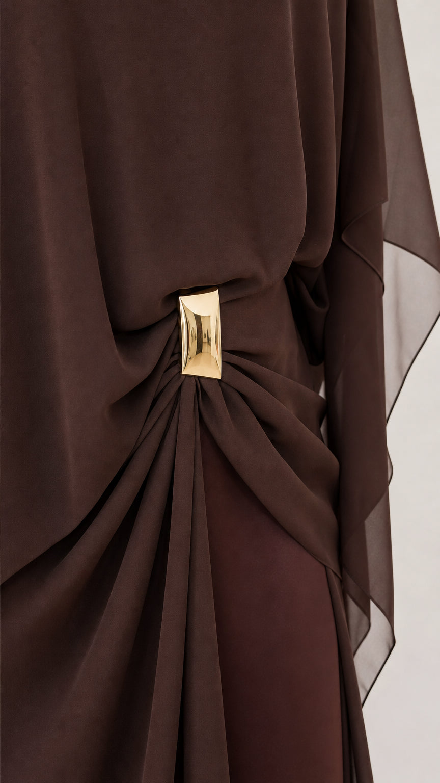 Close-up of gold metal waist cinch detail on Coffee Brown draped dress