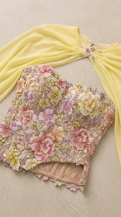 Close-up flat lay of detailed 3D floral embroidered corset bodice and jeweled cape collar