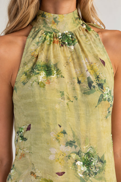 Close-up of high halter neckline showing botanical print and sequin embellishments