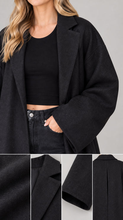 Close-up details of the black maxi coat lapel, fabric texture, and wide cuff