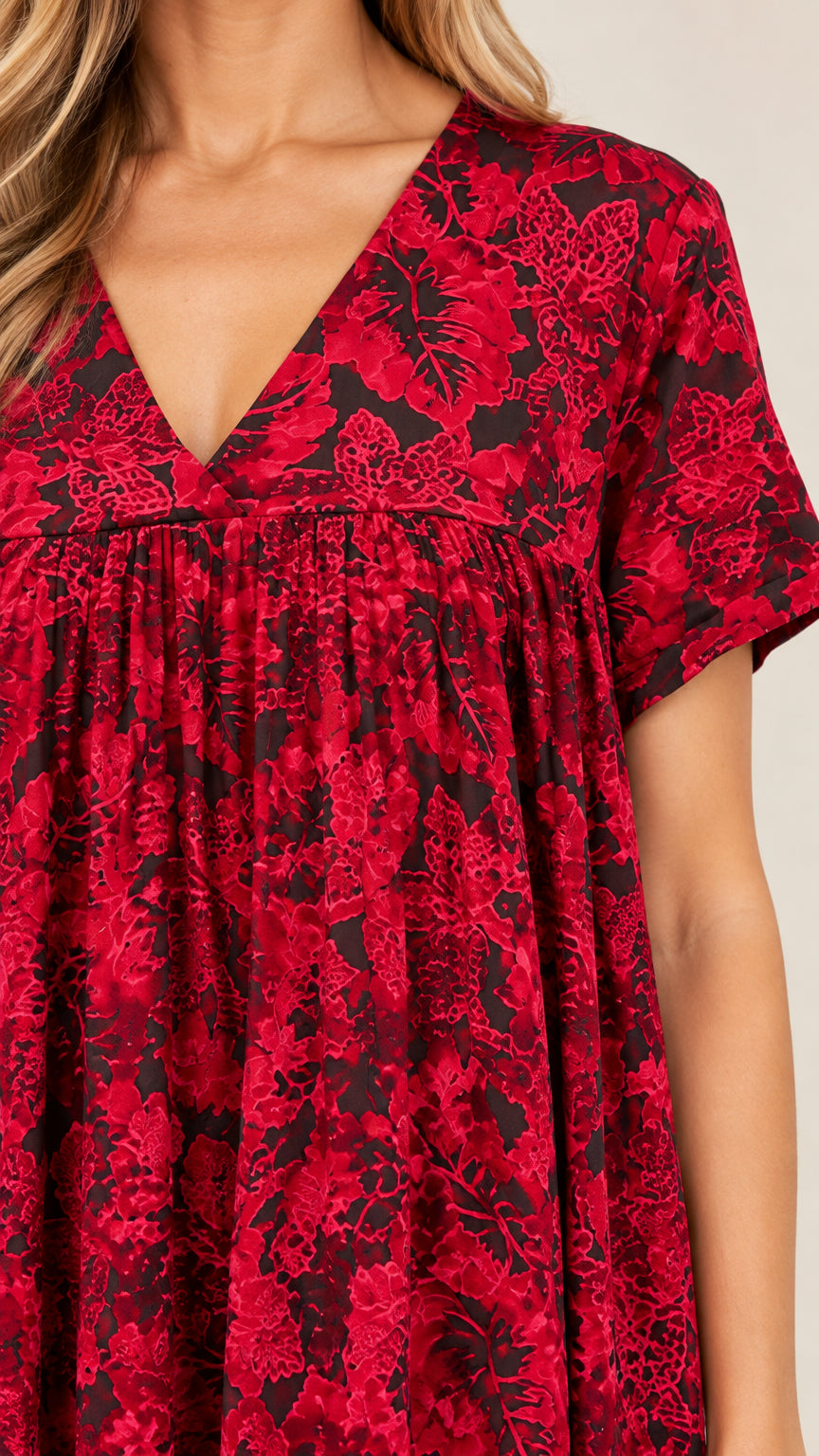 Close-up of V-neckline and gathered bust pleats on red floral maxi dress