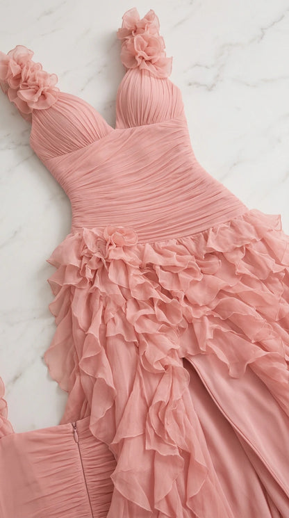 Close-up flat lay of dusty pink gown showing ruched bodice and 3D floral straps