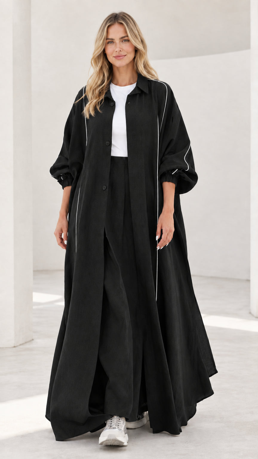 Woman wearing black contrast piping maxi duster coat and wide leg pants two-piece set
