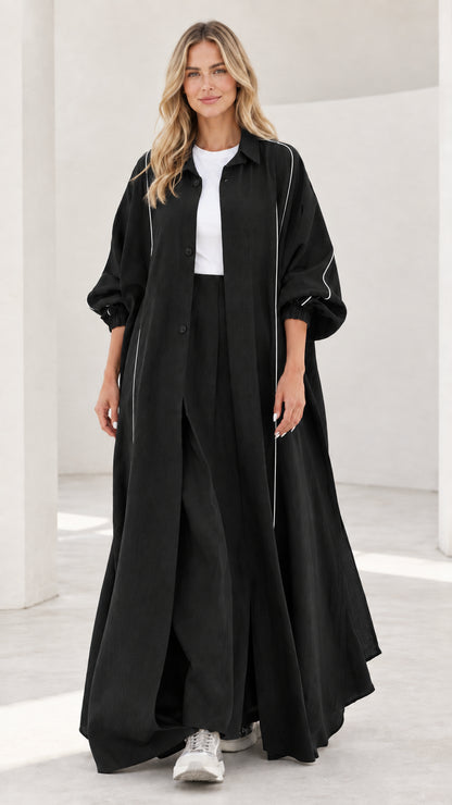 Woman wearing black contrast piping maxi duster coat and wide leg pants two-piece set