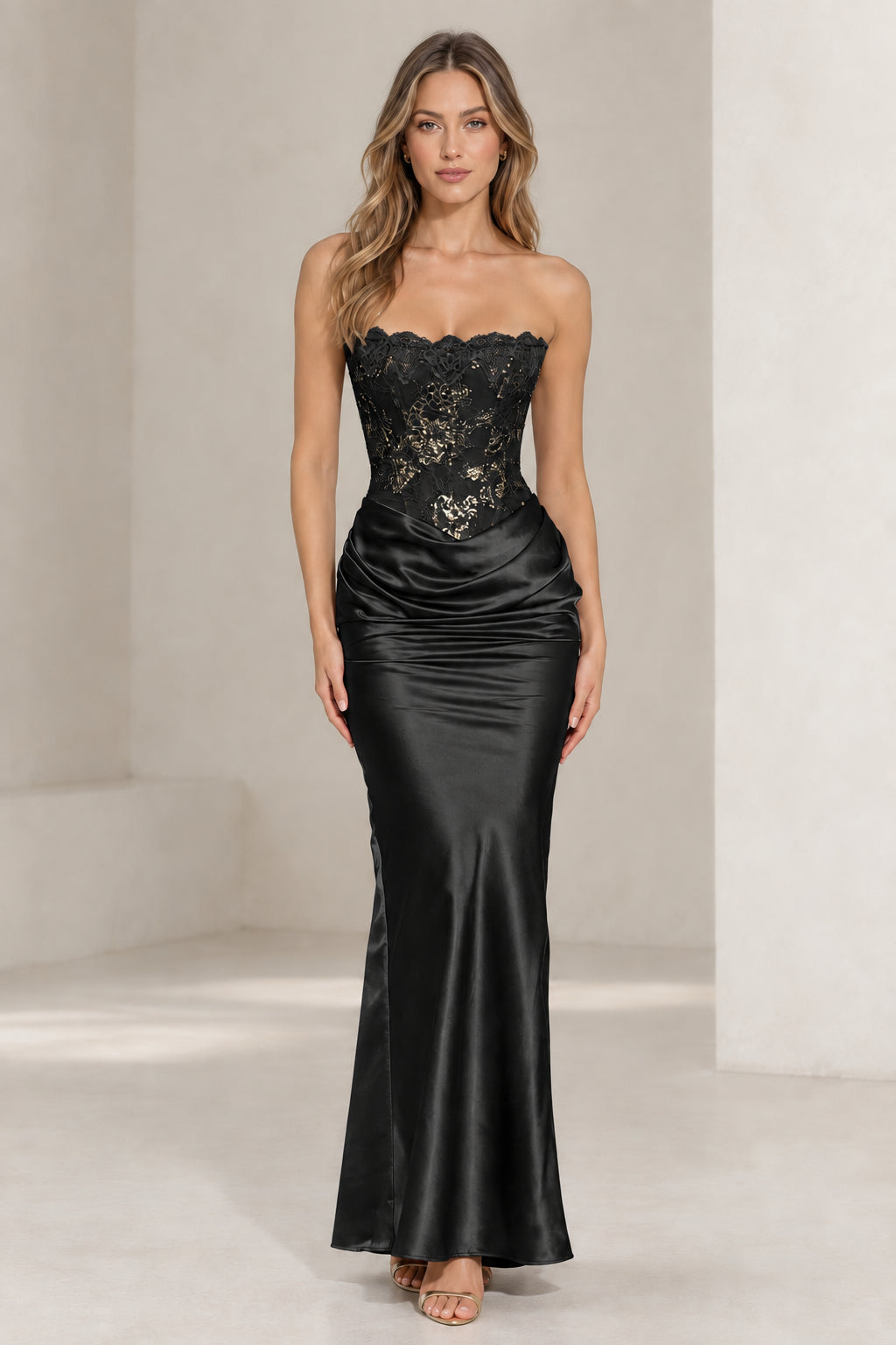 Front view of woman wearing black strapless lace corset satin evening gown