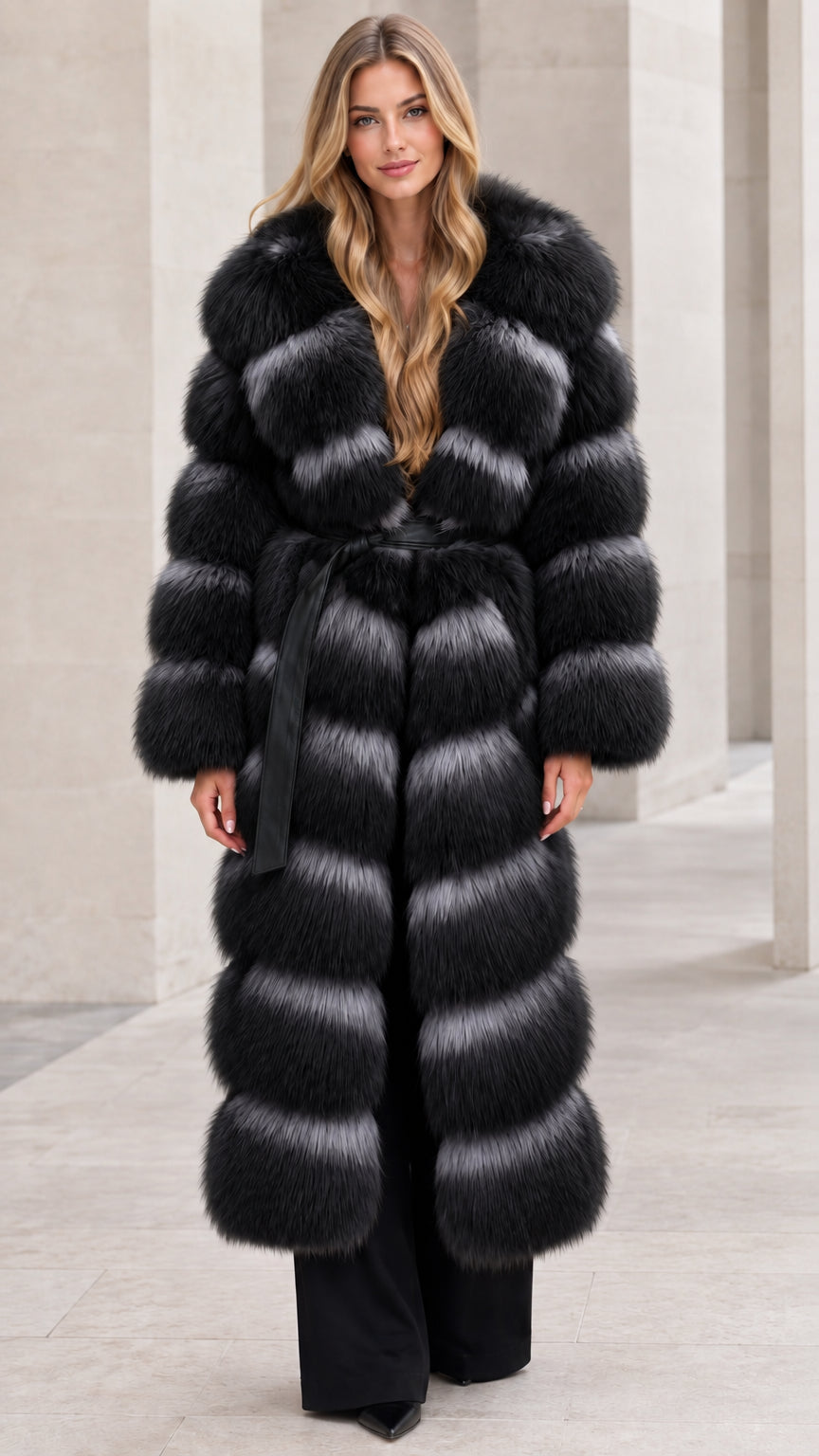 Front full-length view of woman wearing black long tiered faux fur coat with belt