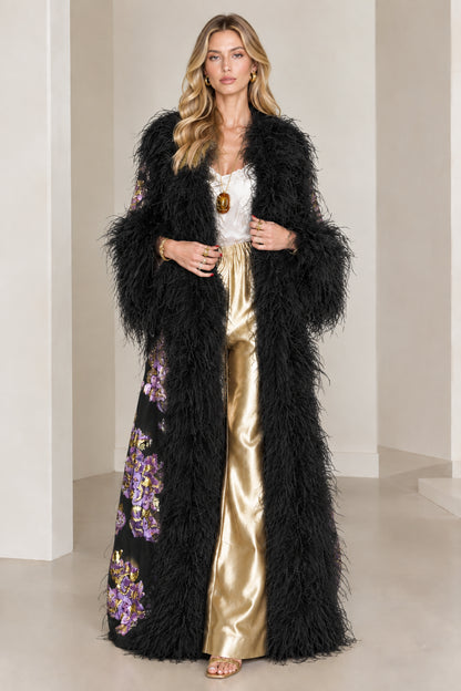 Full-length view of black floral brocade duster coat with black feather trim
