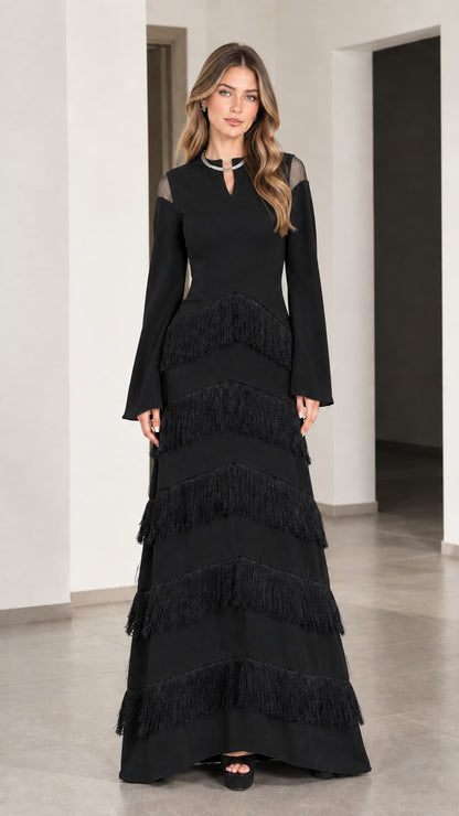Front full view of Black long sleeve tiered fringe maxi evening gown