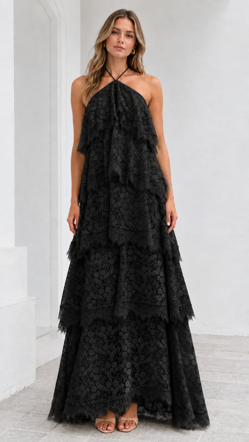 Full-length view of model wearing Black tiered floral lace halter maxi dress