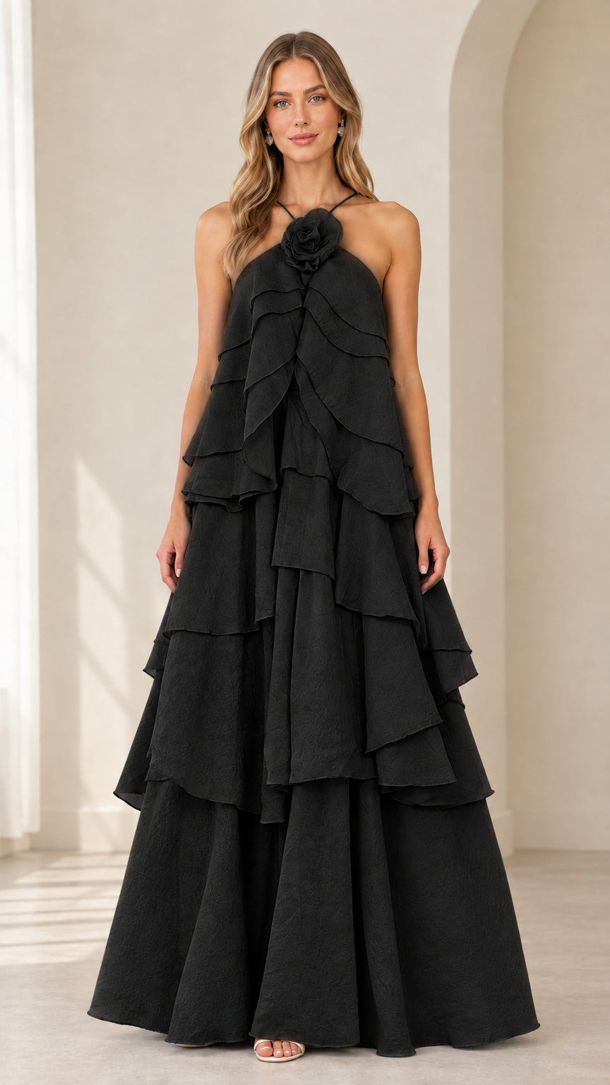Full-length front view of model wearing Black tiered rosette halter maxi dress