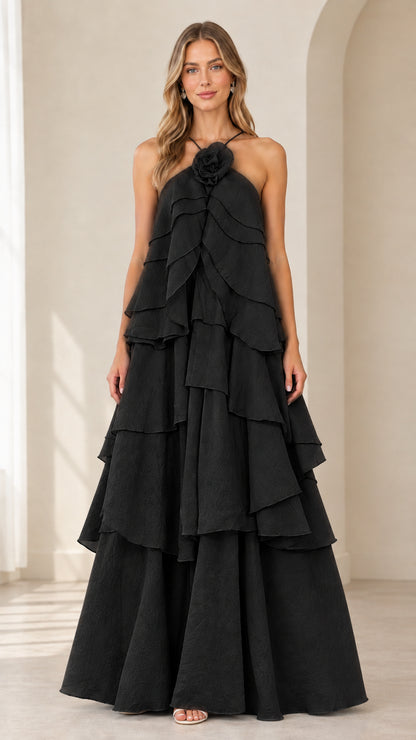 Full-length front view of model wearing Black tiered rosette halter maxi dress