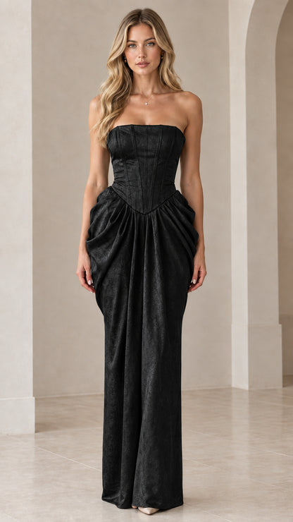 Front view of model wearing Black strapless corset draped maxi evening gown
