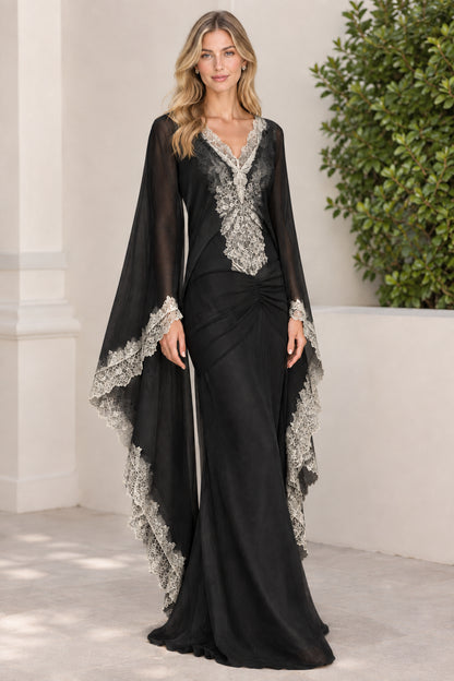 Black formal evening gown with contrasting white lace trim and cape sleeves