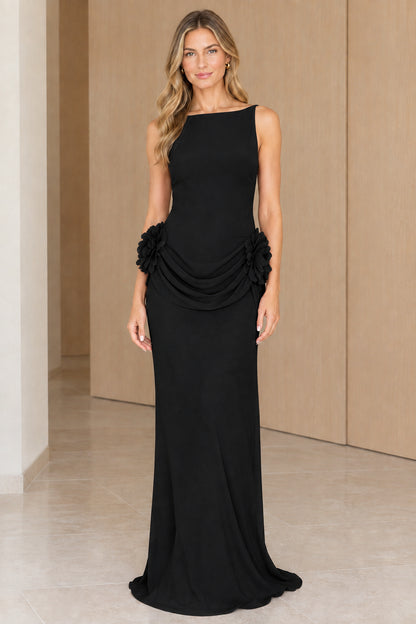 Front view of black sleeveless boatneck maxi dress with floral draped waist