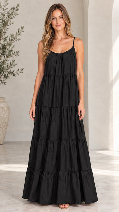 Front view of model wearing black tiered spaghetti strap maxi dress