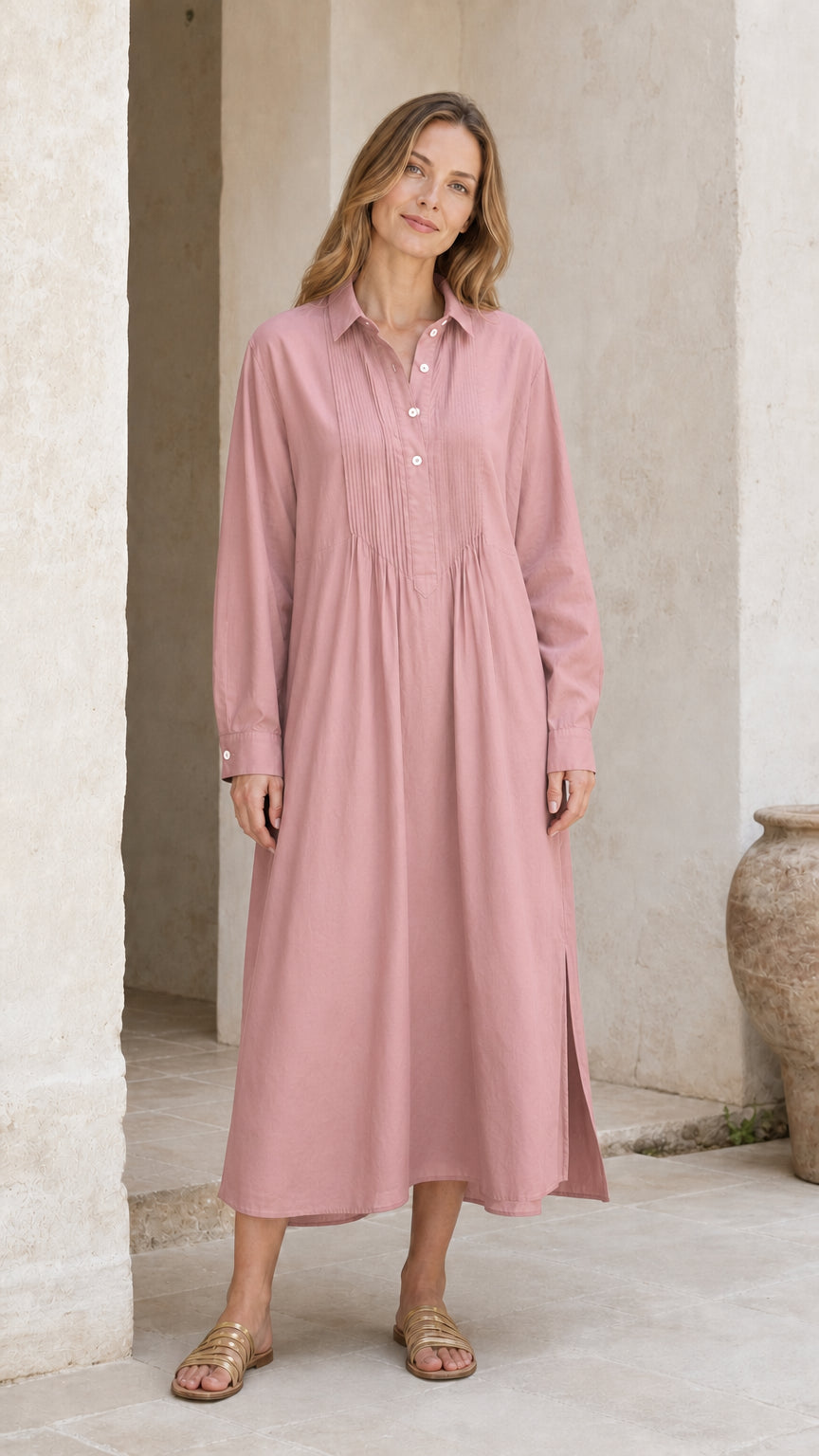 Woman wearing dusty pink long sleeve pleated midi shirt dress