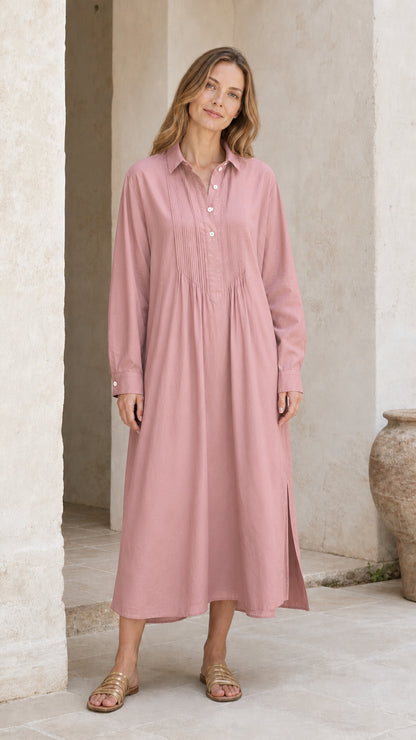 Woman wearing dusty pink long sleeve pleated midi shirt dress