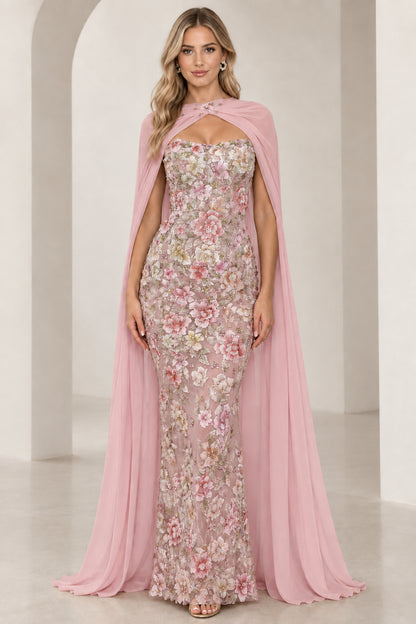 Model wearing blush pink floral embroidered formal gown with matching sheer capelet