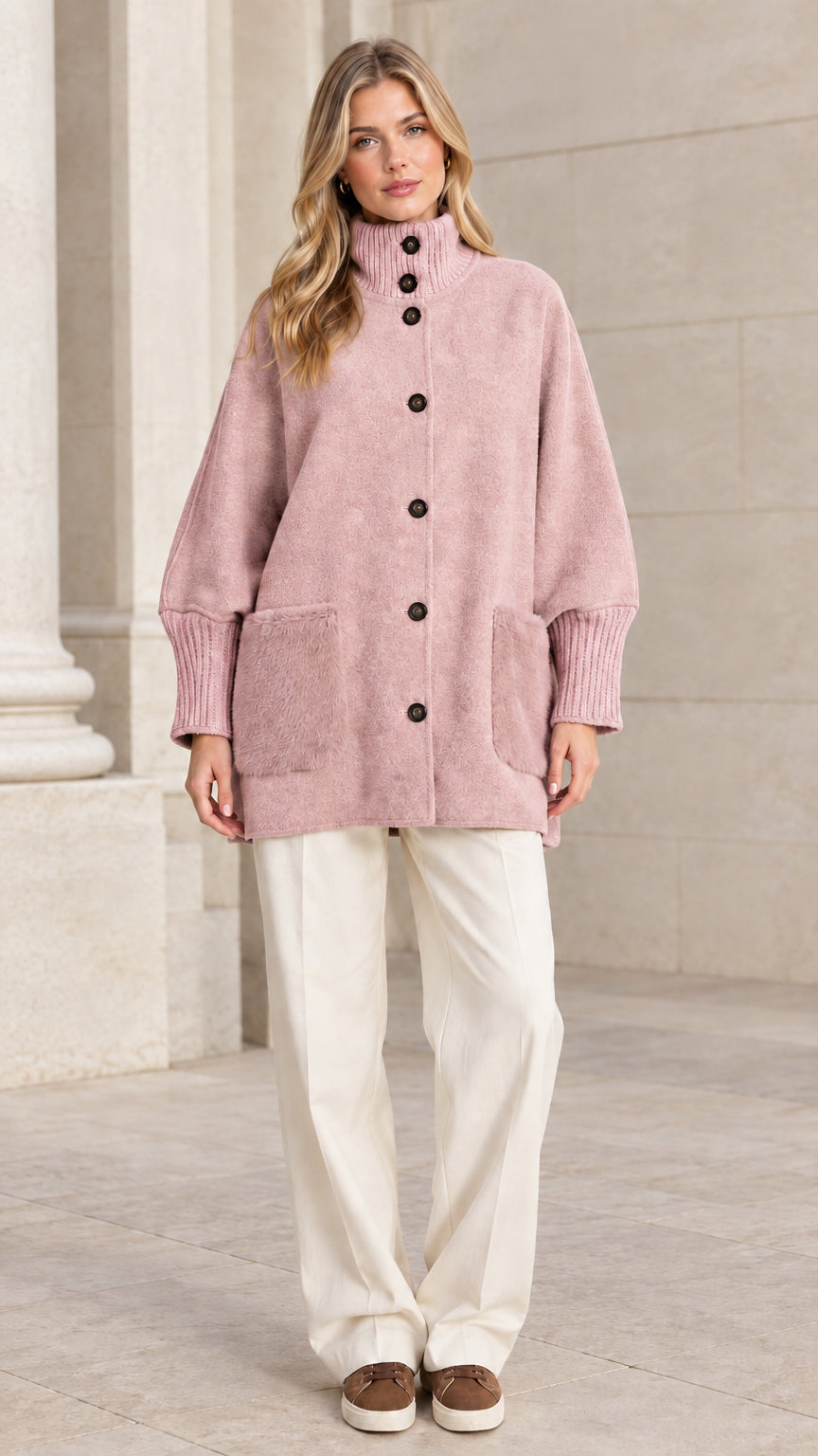 Full front view of a woman wearing a dusty pink mock neck button-down jacket
