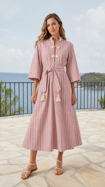 Model wearing soft pink striped midi dress with mandarin collar and tassel belt