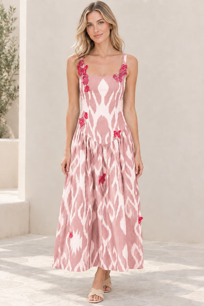 Model wearing blush pink and white ikat print sleeveless maxi dress with butterfly patches