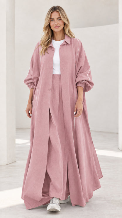 Woman wearing dusty pink maxi duster and matching wide leg trousers set