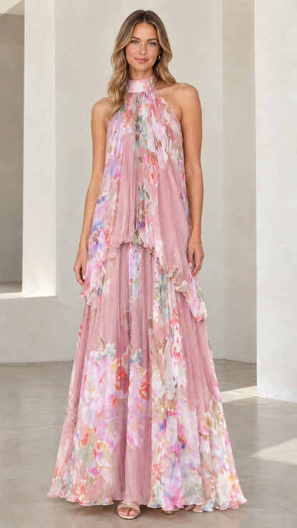 Front view of dusty pink floral halter neck flowing tiered maxi gown
