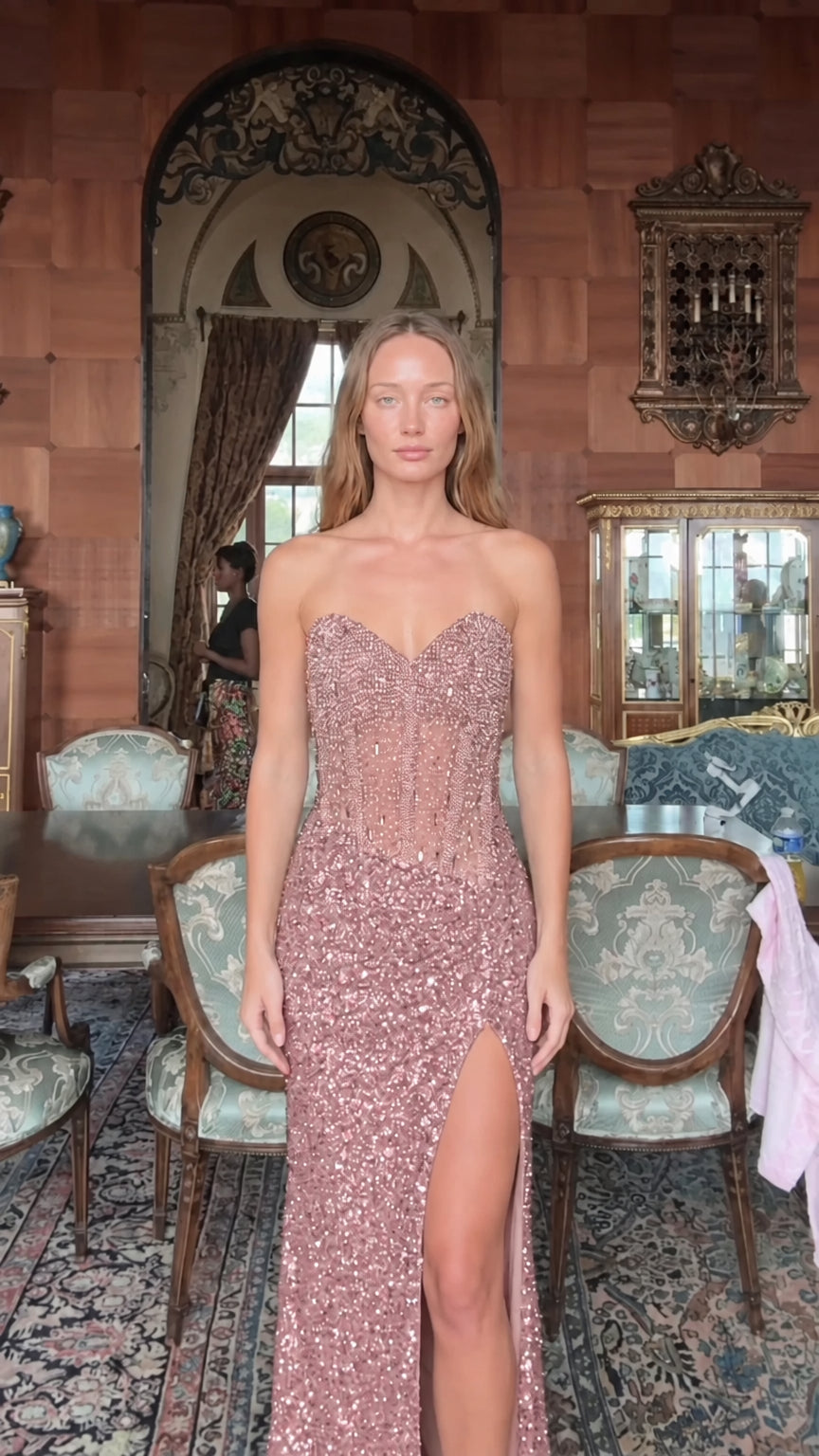Front view of model wearing rose pink strapless sequin corset maxi gown