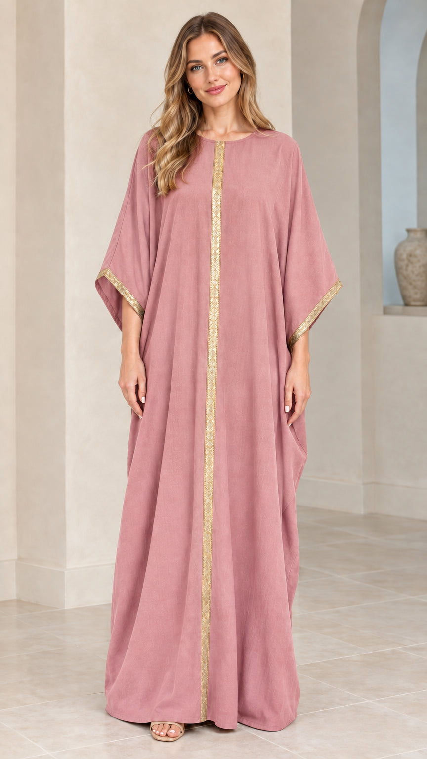 Full front view of model wearing dusty pink kaftan maxi dress with gold trim