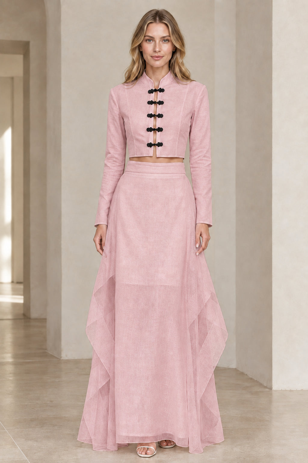 Front view of model wearing soft pink mandarin collar crop top and maxi skirt set