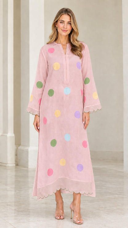 Woman wearing soft pink polka dot long sleeve maxi kaftan dress