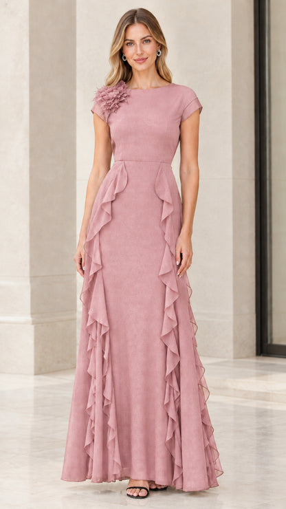 Front view of woman wearing dusty rose floral shoulder ruffle evening gown