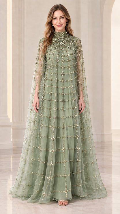 Front full view of woman wearing sage green beaded cape evening gown