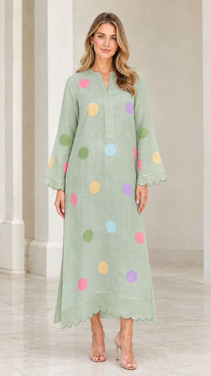Woman wearing sage green polka dot long sleeve maxi kaftan dress