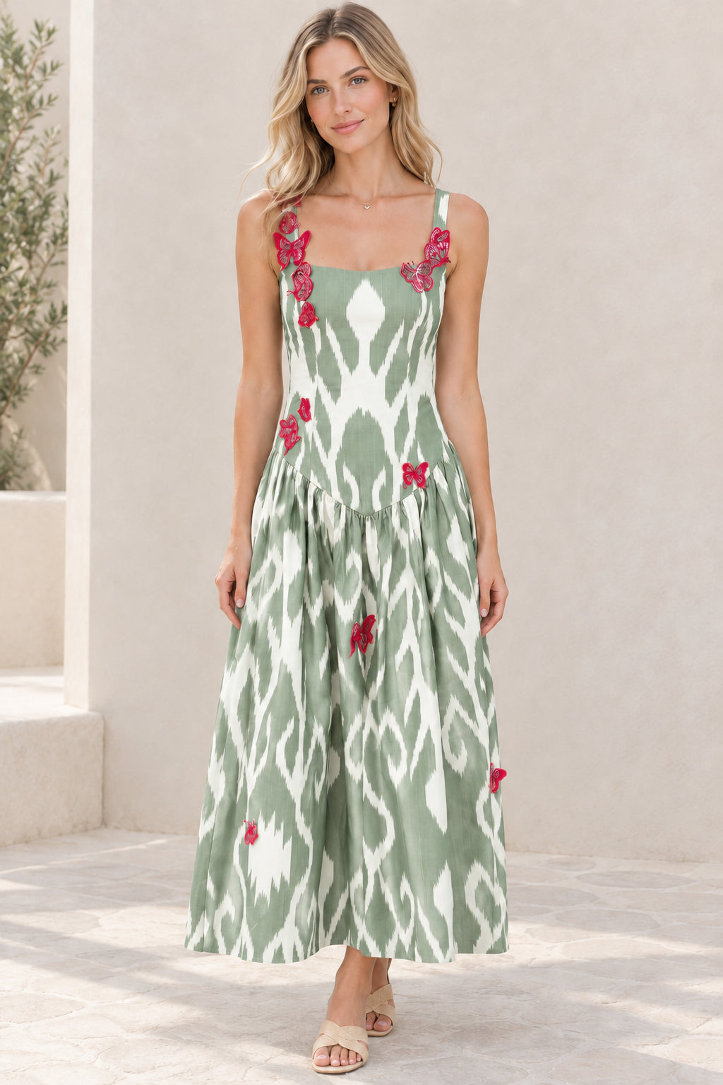 Model wearing sage green and white ikat square neck maxi dress with butterfly details