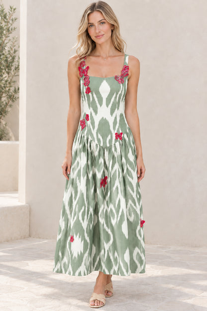 Model wearing sage green and white ikat square neck maxi dress with butterfly details