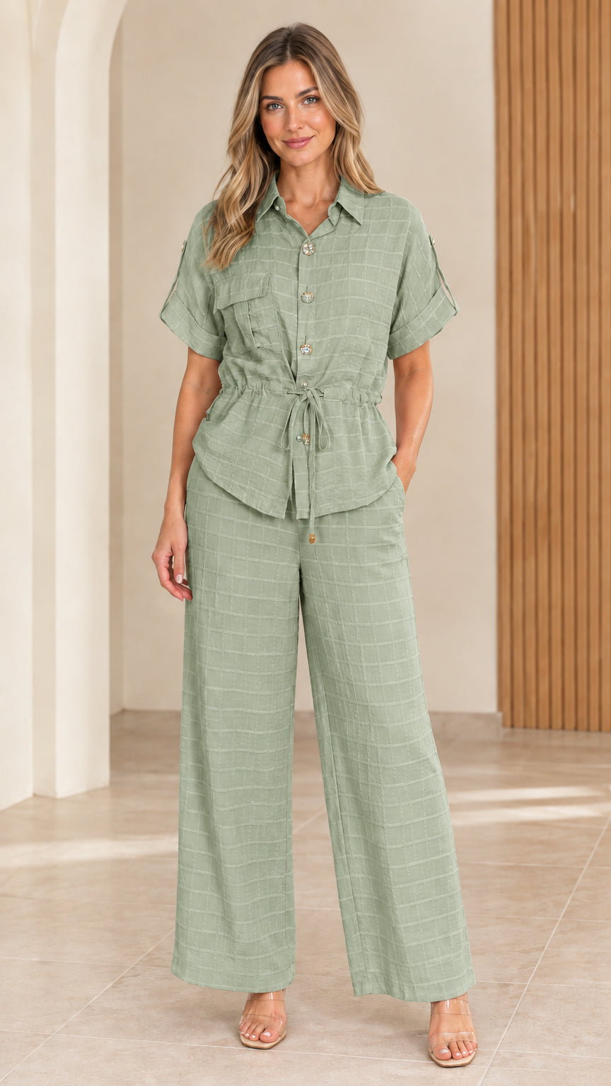 Full front view of model wearing sage green textured two-piece shirt and pant set
