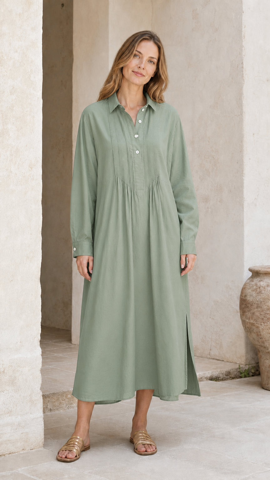 Woman wearing sage green long sleeve pleated midi shirt dress