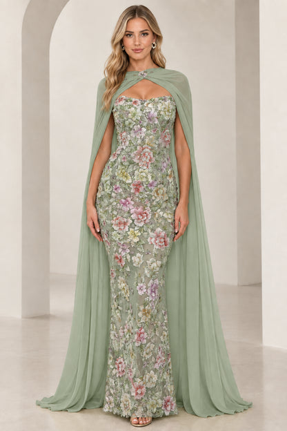 Model wearing sage green floral embroidered strapless gown with elegant chiffon cape